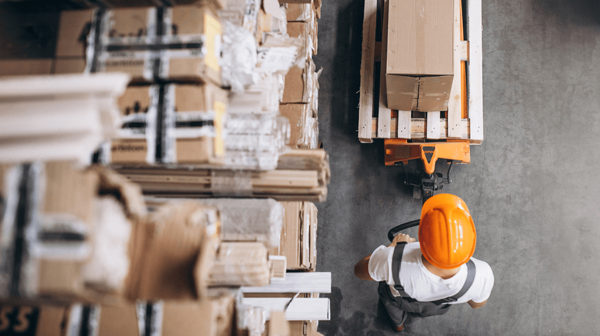 Man in hardhat with boxes. Digital transformation in the logistics industry.