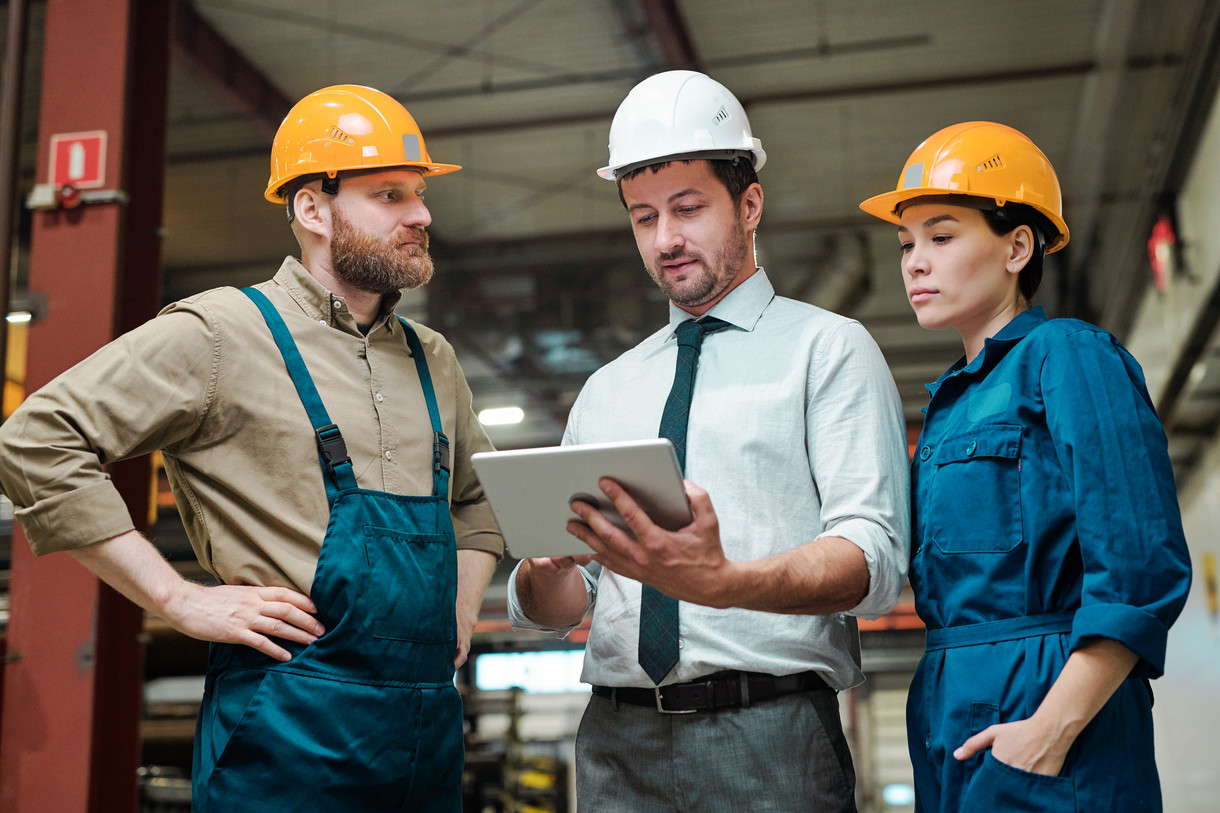 Men in hard hats on a building site.